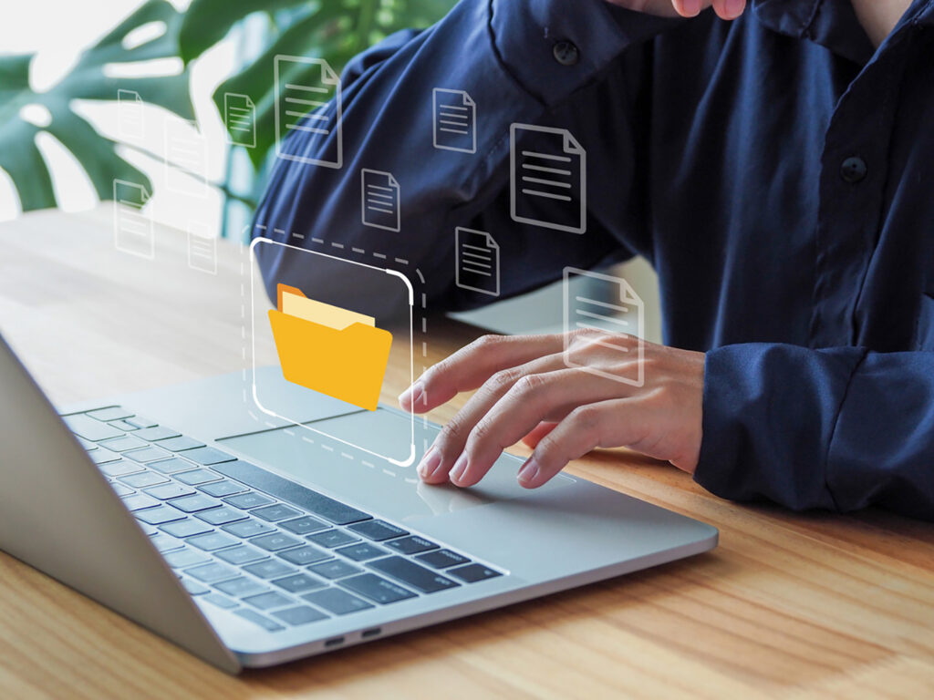 man looking up records on a laptop computer